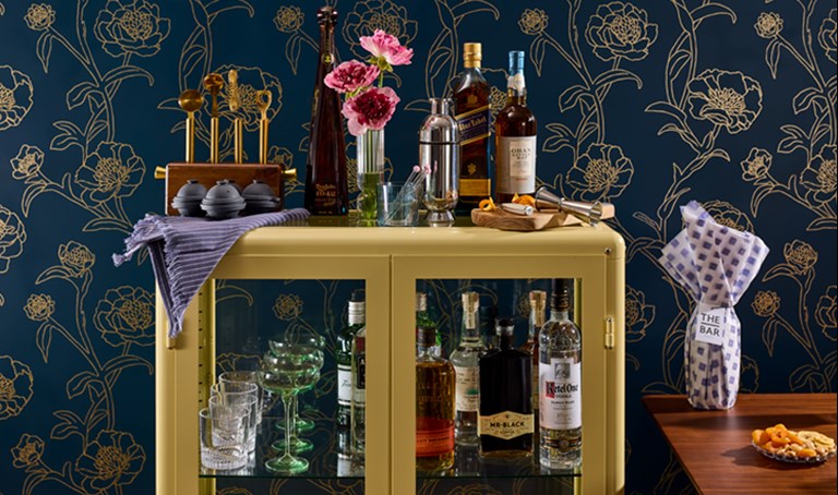 Homebar with bottles barware and flowers