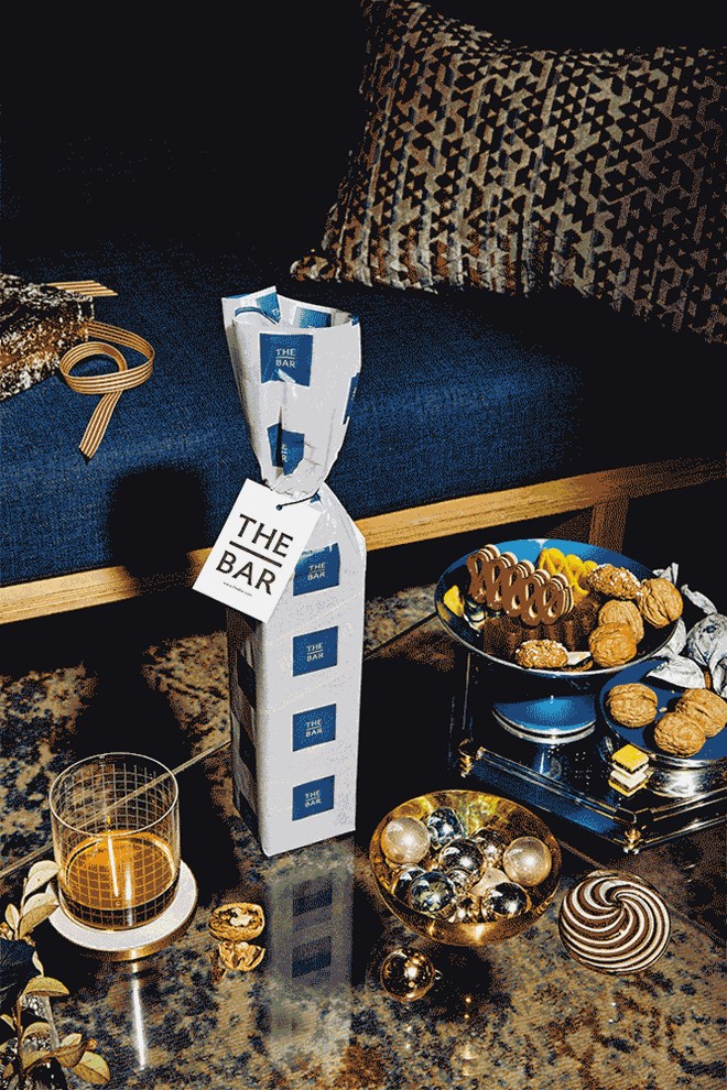 Gif of gift wrapping falling away from bottle of Johnnie Walker Blue Label
